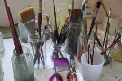 paint brushes in jars