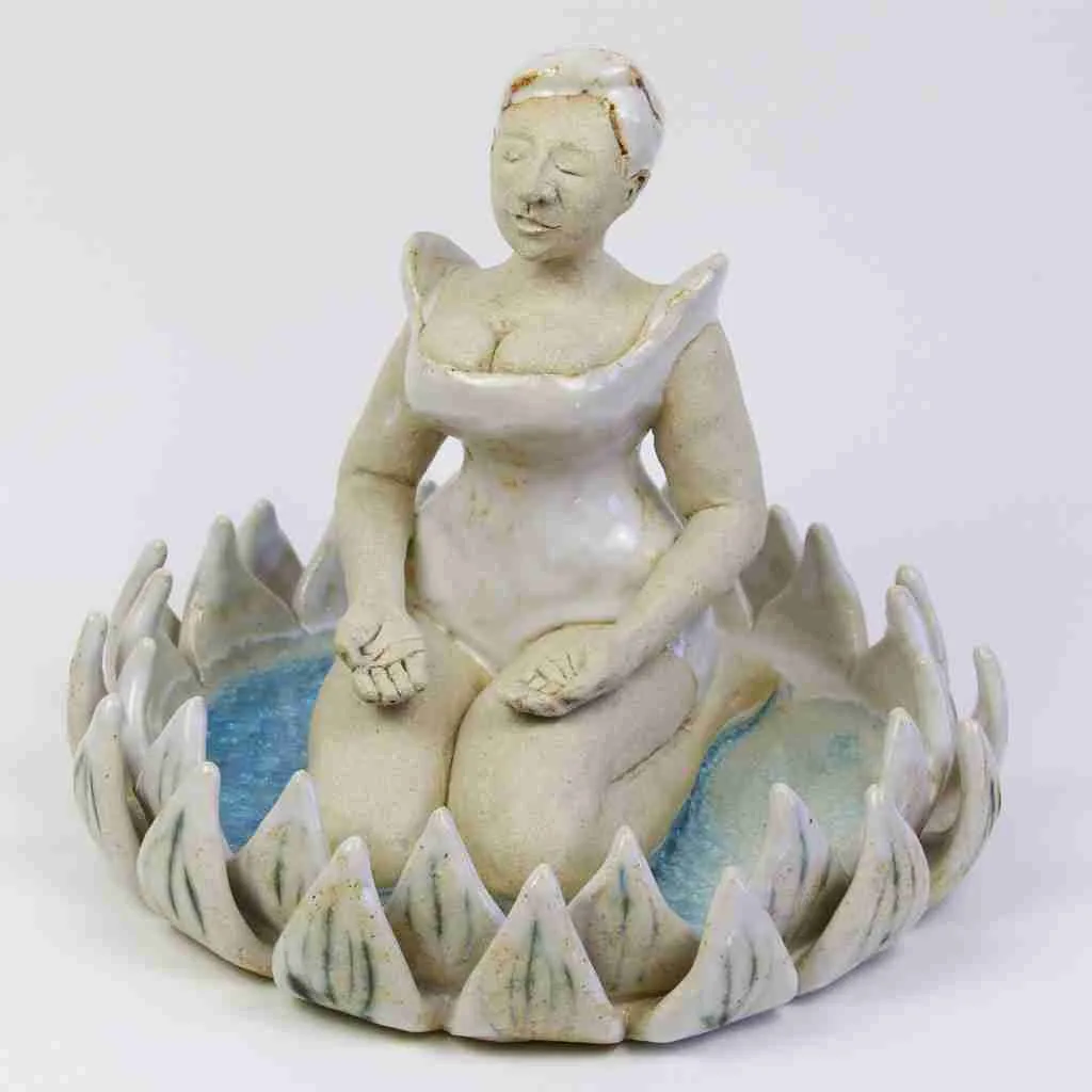 Stoneware sculpture of a lady mediating in a lotus flower
