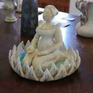 stoneware zen meditation sculpture, woman meditating in a lotus flower