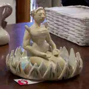 stoneware zen meditation sculpture, woman meditating in a lotus flower