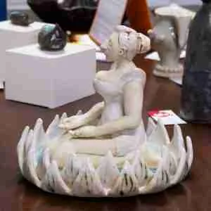 stoneware zen meditation sculpture, woman meditating in a lotus flower