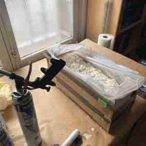 Using expanding foam to make a snug fit for shipping sculptures.