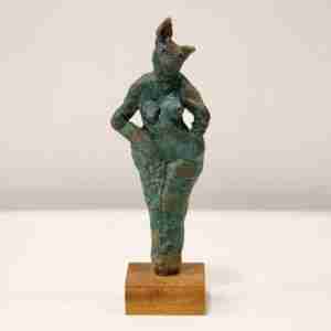 A green stoneware rabbit sculpture on a hard wood base.