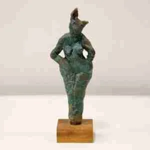 A green stoneware rabbit sculpture on a hard wood base.