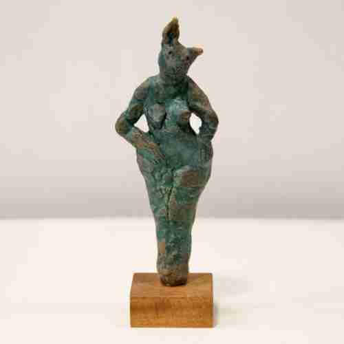 A green stoneware rabbit sculpture on a hard wood base.