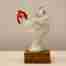 White porcelain hen sculpture on a hardwood base