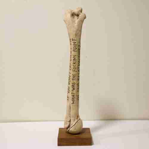 hand-sculpted humerus bone with carved quote