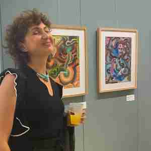 Artist Marianna Magurudumian with her paintings