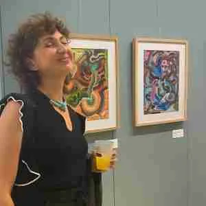 Artist Marianna Magurudumian with her paintings