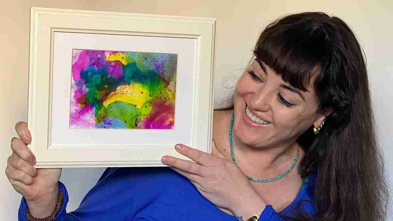 Maggie Field with her watercolour painting made in Emma Plunkett's art studio