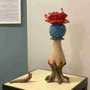 stoneware ceramic sculpture of a flower and a slug
