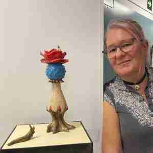 stoneware sculpture of a flower and a slug