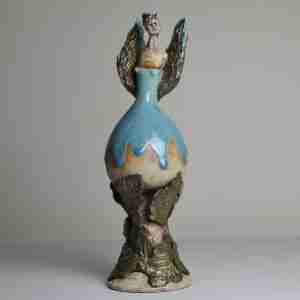 Surreal stoneware angel sculpture with gold leaves and nature
