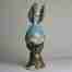 Surreal stoneware angel sculpture with gold leaves and nature
