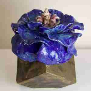 Surreal stoneware sculpture with cube and blue flouncy flower