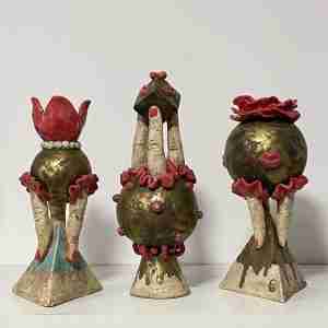 A group of stoneware surreal sculptures, like performers or acrobats but with geometic forms
