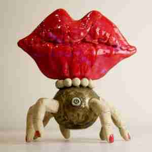 Stoneware surreal sculpture with huge red lips and 8 fingers
