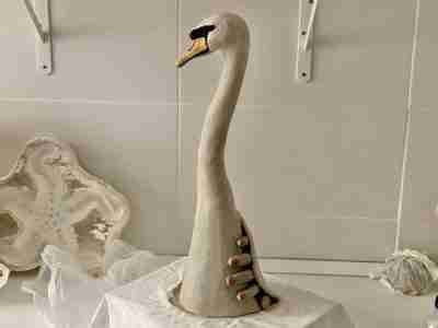 unfired clay swan sculpture