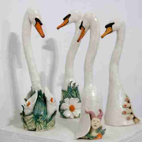 A group of stoneware swan sculptures
