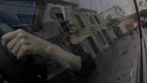 contained fury, a woman lets off steam in a car