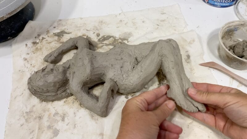 Shaping a figure in the clay. What it feels like to make art